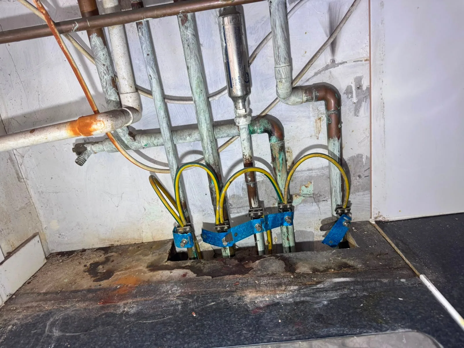 Water pipework exposed beneath a floor
